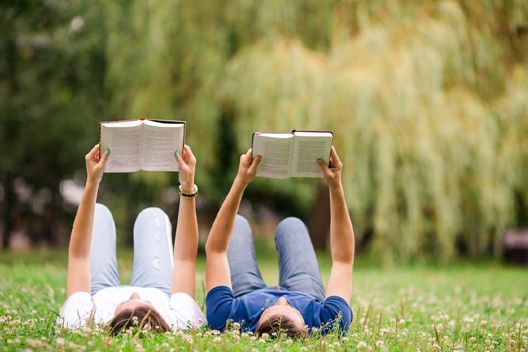 A couple studying together in a field